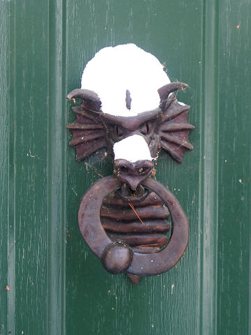 Dragon door knocker with snow