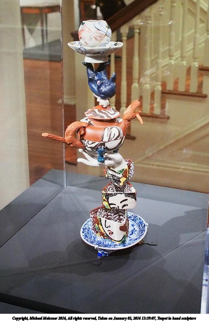 Teapot in hand sculpture
