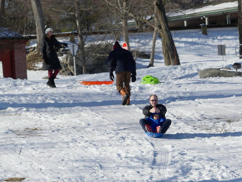 Father and child sledding
