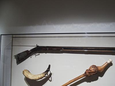 Rifle, powder horn, and cane