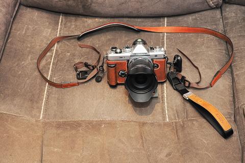 OM-3 with leather case, neck strap, and hand strap